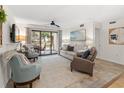 Living area featuring neutral tones, large windows offering abundant natural light, and an inviting atmosphere at 306 Westbury Ct. # 2-B, Myrtle Beach, SC 29572