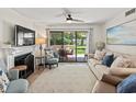 Cozy living room featuring a fireplace, comfortable seating, and sliding glass doors to the outdoor patio at 306 Westbury Ct. # 2-B, Myrtle Beach, SC 29572