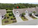 An aerial view highlights the property's landscaping and location in a serene, wooded neighborhood at 3334 Volterra Way # 3334, Myrtle Beach, SC 29579