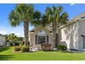 Charming home exterior featuring a brick facade, lush lawn, and decorative palm trees at 347 Kessinger Dr., Surfside Beach, SC 29575