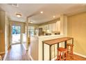 Bright kitchen with a breakfast bar and wooden stools, opening to the entrance at 3565 Crepe Myrtle Ct. # 3565, Myrtle Beach, SC 29577