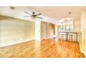 Open-concept living room with hardwood floors, bar seating, and staircase at 3565 Crepe Myrtle Ct. # 3565, Myrtle Beach, SC 29577