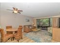 Living room features a dining table, ceiling fan, and sliding glass doors leading to the porch at 415 Ocean Creek Dr. # 2245, Myrtle Beach, SC 29572