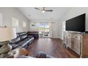 Spacious living room featuring hardwood floors, sliding glass doors and a cozy, neutral color palette at 4359 Livorn Loop # 4359, Myrtle Beach, SC 29579