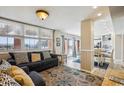 Cozy living room with a large window, sliding doors, and open to the kitchen at 4501 S Ocean Blvd., North Myrtle Beach, SC 29582