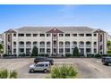 Exterior of a cream-colored, three-story condominium building with private balconies at 4524 N Plantation Harbour Dr. # B3, Little River, SC 29566