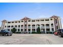 Straight-on exterior of a three-story condo building with a paved parking lot in front at 4524 N Plantation Harbour Dr. # B3, Little River, SC 29566