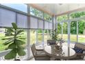 Cozy sunroom with wicker chairs and a glass table, offering a relaxing space with scenic views at 4683 Wild Iris Dr. # 104, Myrtle Beach, SC 29577