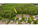 An aerial view of the property nestled amongst trees and adjacent to a lush wooded area in a quiet community at 475 Misty Hammock Dr. # 475, Murrells Inlet, SC 29576