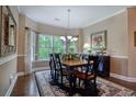Formal dining room featuring a large window, a chandelier, and hardwood floors, creating an elegant atmosphere at 475 Misty Hammock Dr. # 475, Murrells Inlet, SC 29576