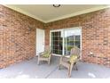 Covered patio with brick and seating, a sliding glass door, and a view of the complex at 4812 Magnolia Lake Dr. # 102, Myrtle Beach, SC 29577