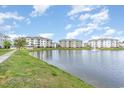 A large pond surrounded by lush green grass and multiple condo buildings at 4812 Magnolia Lake Dr. # 102, Myrtle Beach, SC 29577