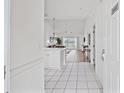 Bright foyer with tiled floor leading to an open living space with hardwood flooring and lots of natural light at 4879 Dahlia Ct. # 302, Myrtle Beach, SC 29577