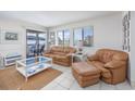 Cozy living room featuring comfortable seating, tile floors, and a view of the exterior balcony at 5001 N Ocean Blvd. # 1F, North Myrtle Beach, SC 29582
