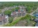 Aerial view of the condo building and surrounding neighborhood with a red location marker at 501 Maison Dr. # G-7, Myrtle Beach, SC 29572