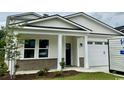Charming single-story home boasts a two-car garage, covered front porch, and appealing curb appeal at 522 6Th Ave. S, North Myrtle Beach, SC 29582