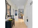 Bright hallway featuring tile flooring, decorative mirror, and artwork that leads to living area at 5840 Longwood Dr. # 303, Murrells Inlet, SC 29576