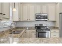 Close-up of kitchen with stainless steel appliances and granite counters at 616 S Palmetto Way, Surfside Beach, SC 29575