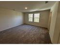 Cozy bedroom with plush carpet and a view of the outdoors through the window at 635 Muster Field Ct., Conway, SC 29526