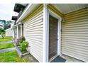 Tan vinyl sided condo with front door and flower garden at 755 Burcale Rd. # D6, Myrtle Beach, SC 29579