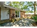Inviting outdoor patio area with brick accents and lush greenery at 816 Kittiwake Ln., Murrells Inlet, SC 29576