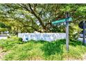 Community entrance sign with lush landscaping and mature trees providing shade at 816 Kittiwake Ln., Murrells Inlet, SC 29576