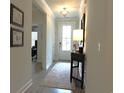 Inviting entryway with light-colored walls, a decorative rug, and crown molding at 932 Mildred Ct., Murrells Inlet, SC 29576