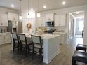 Spacious kitchen featuring white cabinets, stainless steel appliances, and a large center island with seating at 932 Mildred Ct., Murrells Inlet, SC 29576