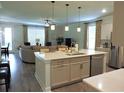 Open-concept kitchen with a center island flowing into the living room, perfect for entertaining at 932 Mildred Ct., Murrells Inlet, SC 29576