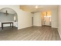 Open living room features vaulted ceilings, neutral walls, and light wood-look flooring at 9569 Indigo Club Dr., Murrells Inlet, SC 29576