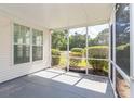 Relaxing screened porch with vinyl siding and views of the private, green backyard at 9569 Indigo Club Dr., Murrells Inlet, SC 29576