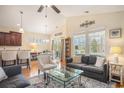 Bright living room with a ceiling fan, large windows, stylish furniture, and an open layout at 967 Henry James Dr., Myrtle Beach, SC 29579