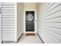 Close-up of a stylish black front door with a decorative wreath and modern hardware at 112 Carolina Lakes Blvd., Myrtle Beach, SC 29588