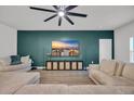 Cozy living room with a modern ceiling fan, large TV, and comfortable seating at 112 Carolina Lakes Blvd., Myrtle Beach, SC 29588