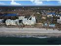 Stunning aerial view showcasing the beachfront condos, white sandy beach, and beautiful ocean at 125 South Dunes Dr., Pawleys Island, SC 29585