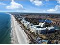 Panoramic aerial view featuring beachfront condo community along a scenic coastline at 125 South Dunes Dr., Pawleys Island, SC 29585