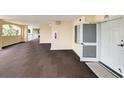 Well-lit hallway with carpet flooring leading to the unit's entrance, with exits nearby at 125 South Dunes Dr., Pawleys Island, SC 29585