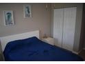 Cozy bedroom featuring a plush bed, nautical-themed art, and a spacious closet at 1266 River Oaks Dr. # 12-F, Myrtle Beach, SC 29579