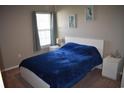 Bright bedroom with a comfortable bed, coastal decor, and natural light at 1266 River Oaks Dr. # 12-F, Myrtle Beach, SC 29579