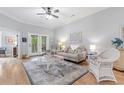 Cozy living room with natural light, neutral decor, ceiling fan, and outdoor access at 144 Puffin Dr. # 3C, Pawleys Island, SC 29585