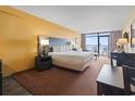 Comfortable main bedroom featuring a king-size bed, sitting area, and a balcony with beautiful ocean views at 1501 S Ocean Blvd. # 1231, Myrtle Beach, SC 29577