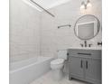 Bright bathroom showcasing a tub, stylish vanity, modern fixtures, and tiled walls at 23 Gabe Pl., Pawleys Island, SC 29585
