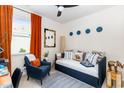 Cozy bedroom featuring a daybed, chair, large window, neutral walls, and decorative accents at 252 Legends Village Loop, Myrtle Beach, SC 29579
