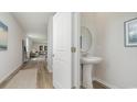 Half bath featuring a pedestal sink, neutral walls, and a view of living area at 2879 Riverboat Way, Conway, SC 29526