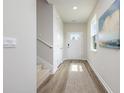 Inviting hallway featuring modern wood flooring and ample natural light from the window at 2879 Riverboat Way, Conway, SC 29526