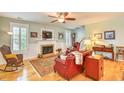 Comfortable living room featuring a fireplace, hardwood floors, and stylish furnishings at 305 Goddard Ln., Murrells Inlet, SC 29576