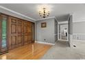 Inviting entryway featuring beautiful hardwood floors and elegant double doors at 3173 Long Avenue Ext., Conway, SC 29526