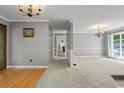 Spacious living room featuring plush carpeting, chandelier, and ample natural light at 3173 Long Avenue Ext., Conway, SC 29526