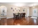 Elegant dining room featuring hardwood floors, a chandelier, and seating for six, perfect for Gathering meals at 325 Galway Ct., Longs, SC 29568