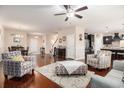 Spacious open-concept living area featuring hardwood floors, a ceiling fan, and seamless flow into dining and kitchen at 325 Galway Ct., Longs, SC 29568